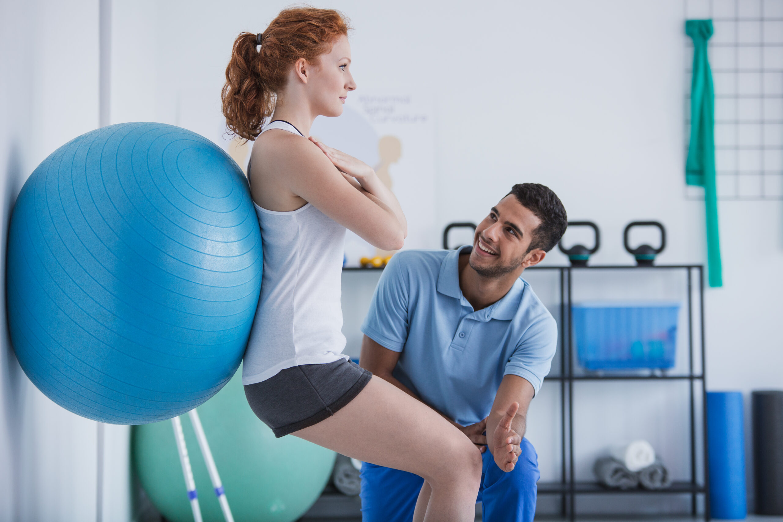 Physical therapist assisting a patient during their physical therapy recovery