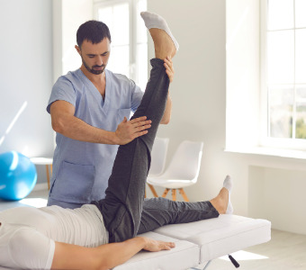 Physical therapist helping a patient recover from injury